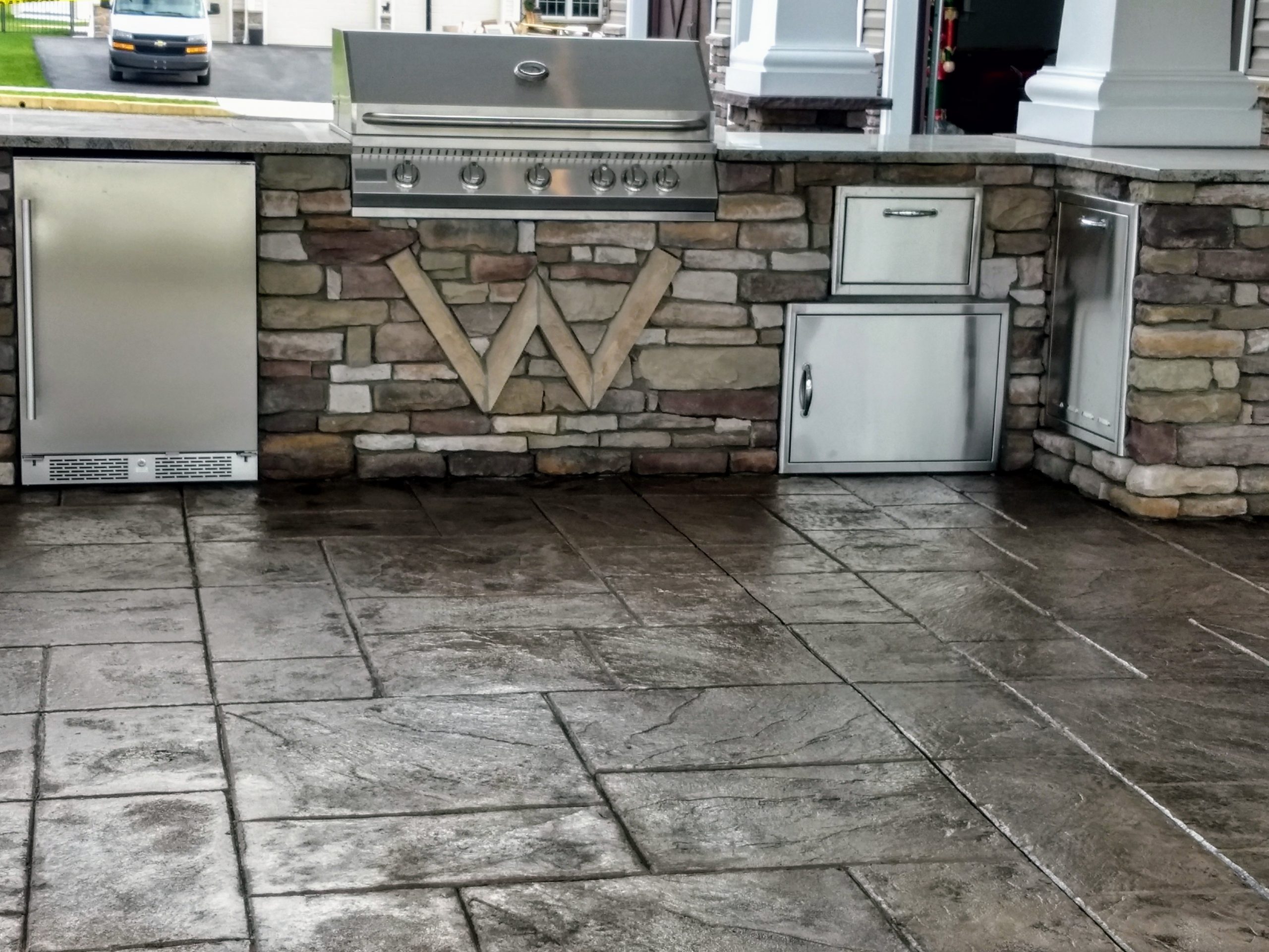 outdoor kitchen with stone tiles and natural stone brick forming counters and floors